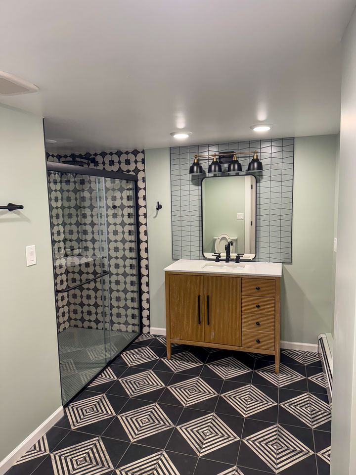 Bathroom with patterned floor tile and wood vanity